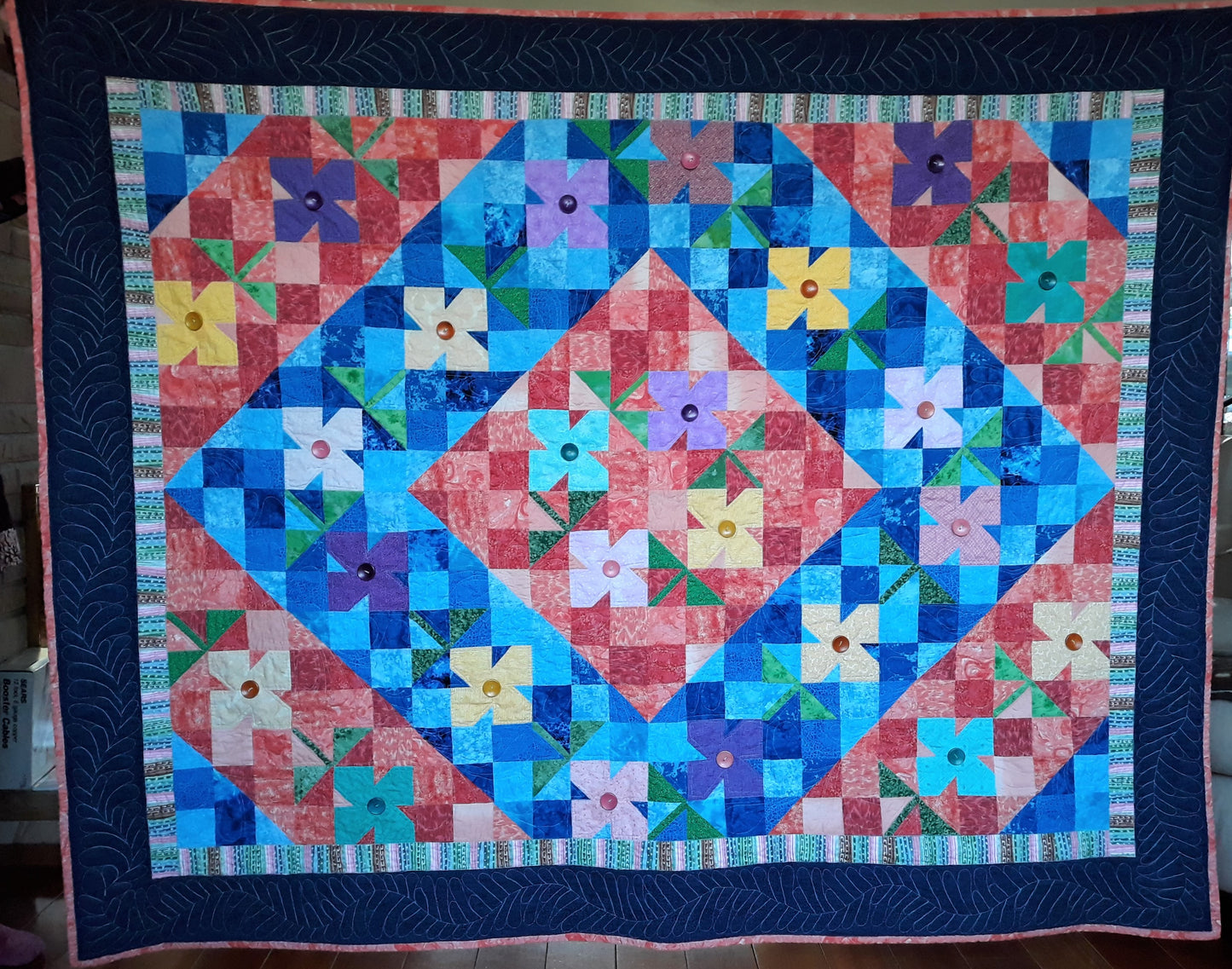 WindBlown Blossoms Quilt 64 x 80 inches, Blue and Coral, two sided quilt, handmade, geometric with colored flowers wooden button centers