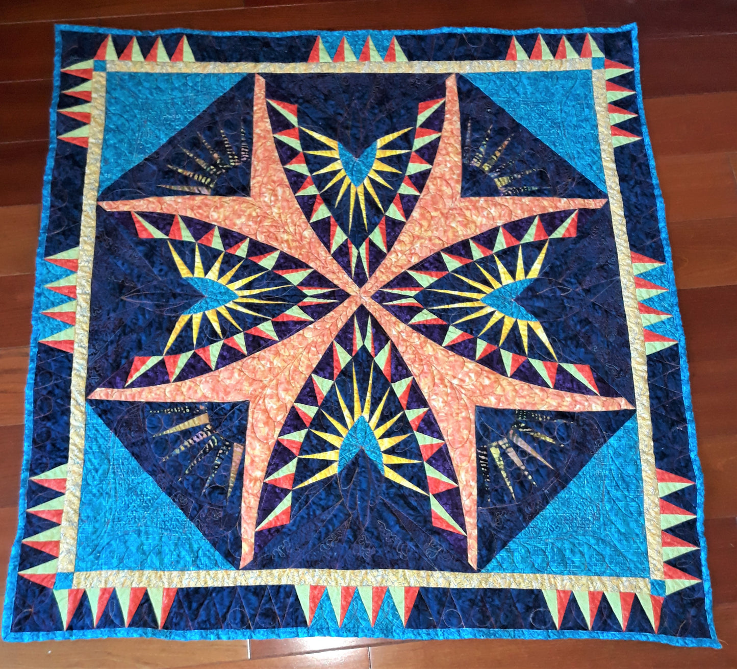 A Spikey Spike Medallion Small Quilt or Wall Hanging, 42 x 42 inches, Bold colors, Geometric design with extensive quilting, teal orange blue yellow