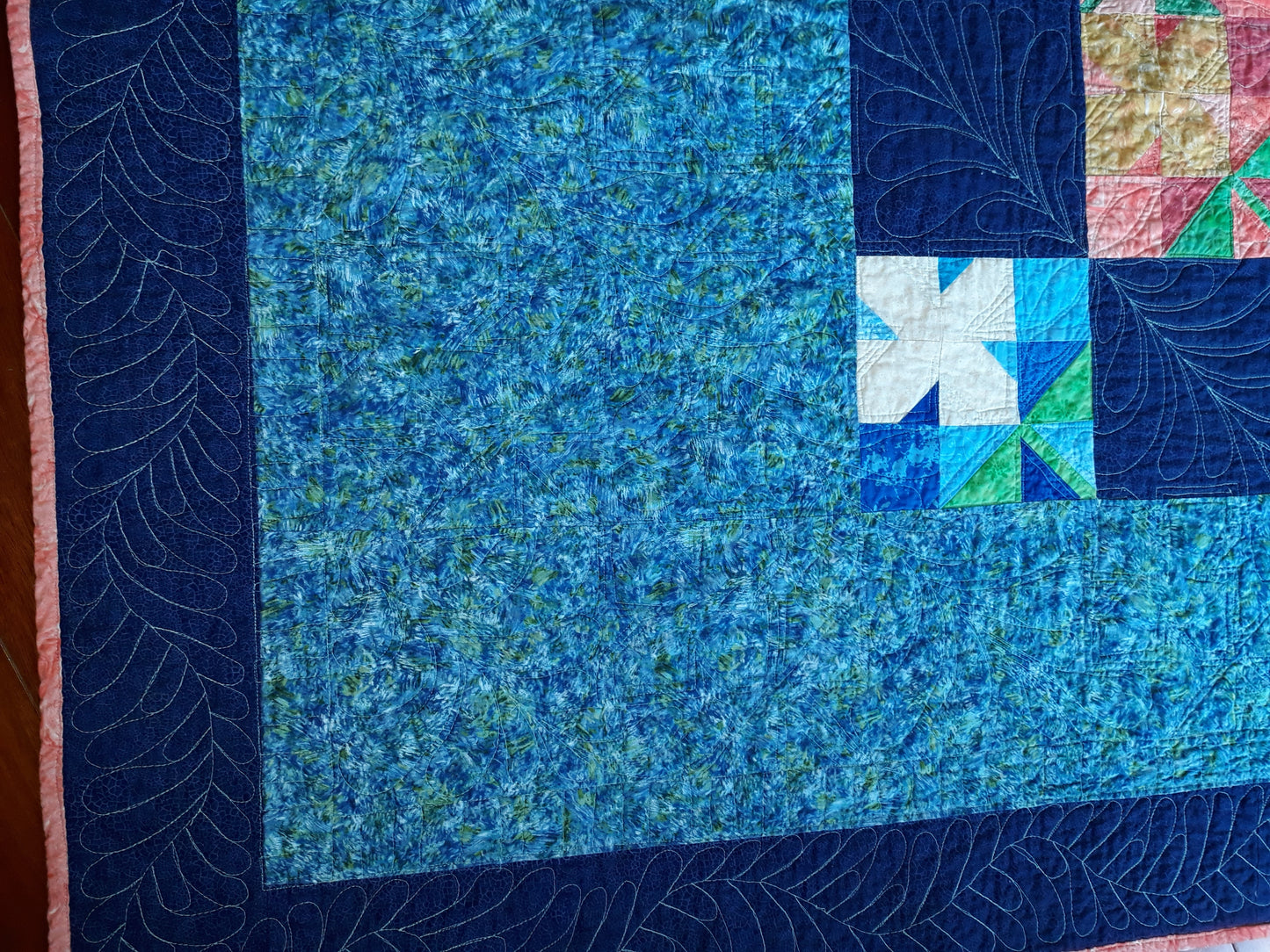 WindBlown Blossoms Quilt 64 x 80 inches, Blue and Coral, two sided quilt, handmade, geometric with colored flowers wooden button centers