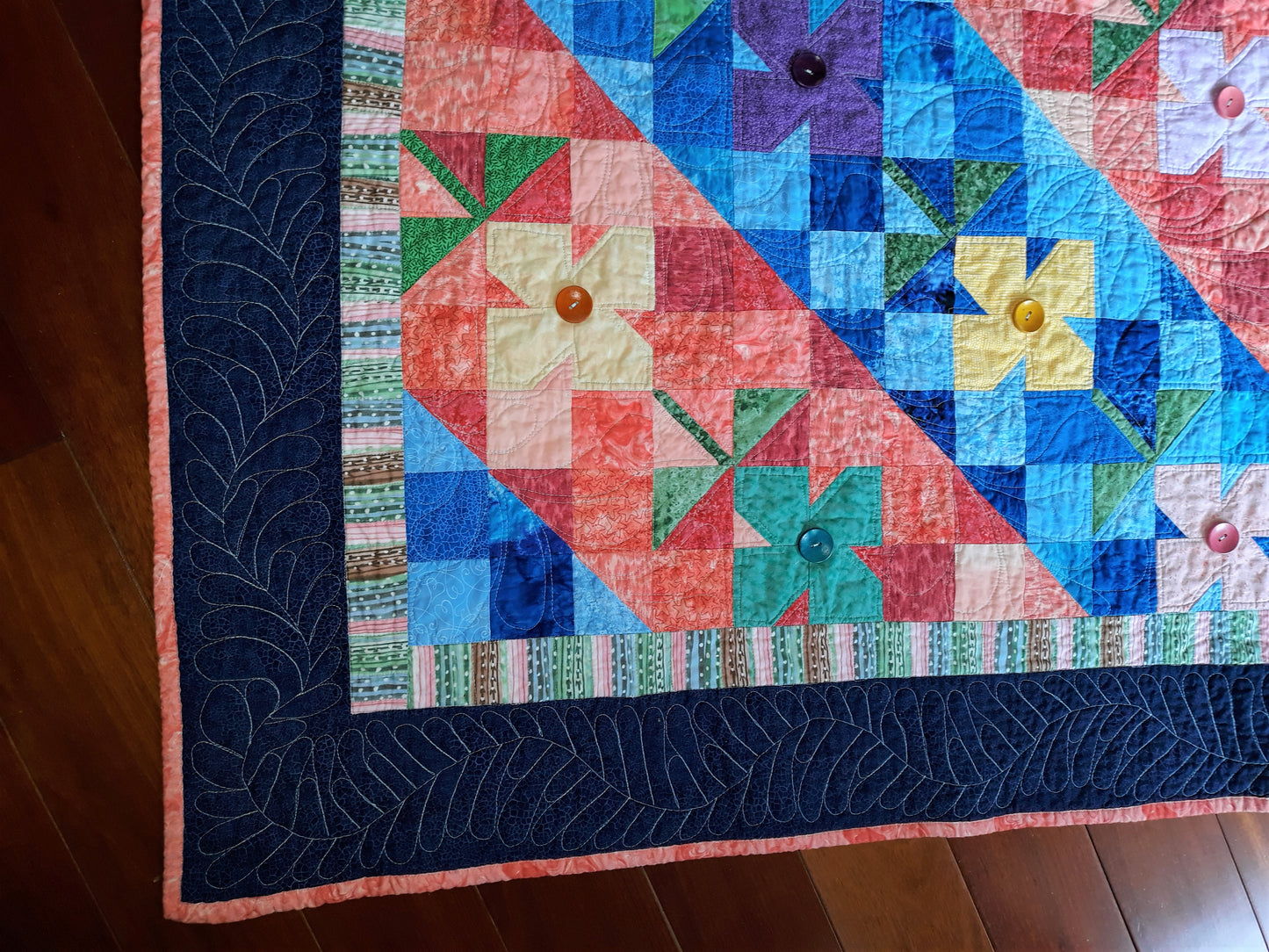 WindBlown Blossoms Quilt 64 x 80 inches, Blue and Coral, two sided quilt, handmade, geometric with colored flowers wooden button centers